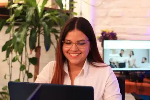Female freelancer smiling at the computer working at the office