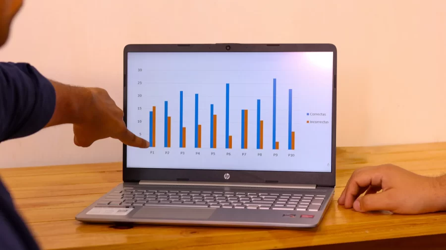 A man showcases impressive statistics on his laptop screen.