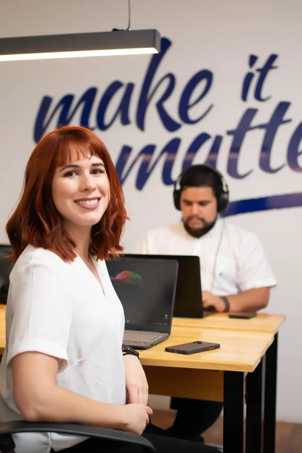 A female freelancer smiling in front of the computer