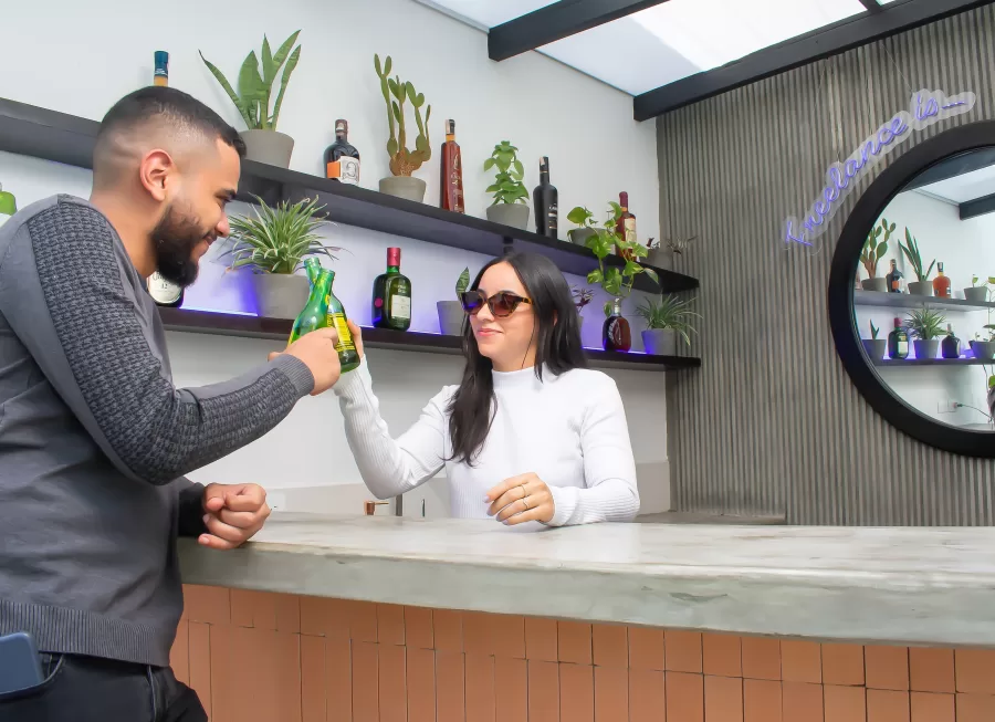 Two freelancers toasting in a pool bar