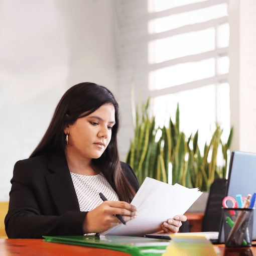 A freelancer at the office reviewing some documents