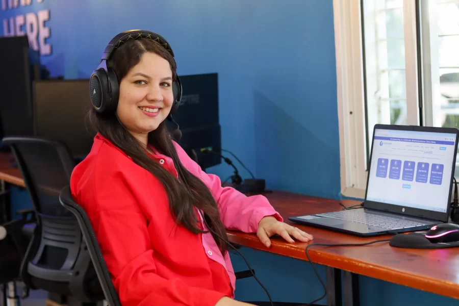 A girl working in front of a computer and smiling