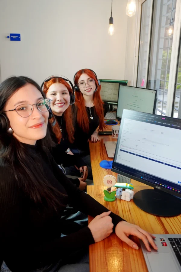 Customer support specialists from Latin America wearing headsets in a modern office, delivering fully managed remote staffing solutions for U.S. and Canadian companies.