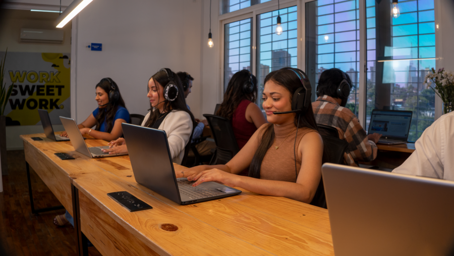 Remote team using their laptops in a Latin American coworking space.